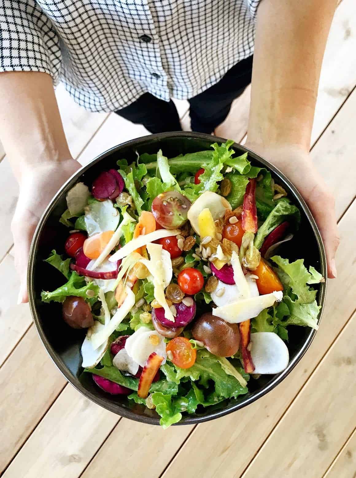 Harvest Haven Salad held by hands