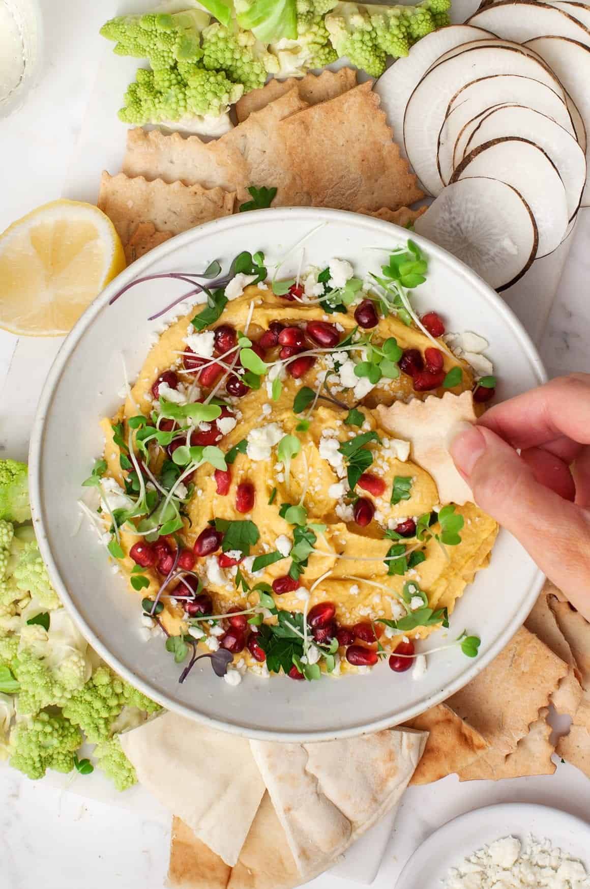 Butternut Hummus with Feta & Pomegranates in a bowl