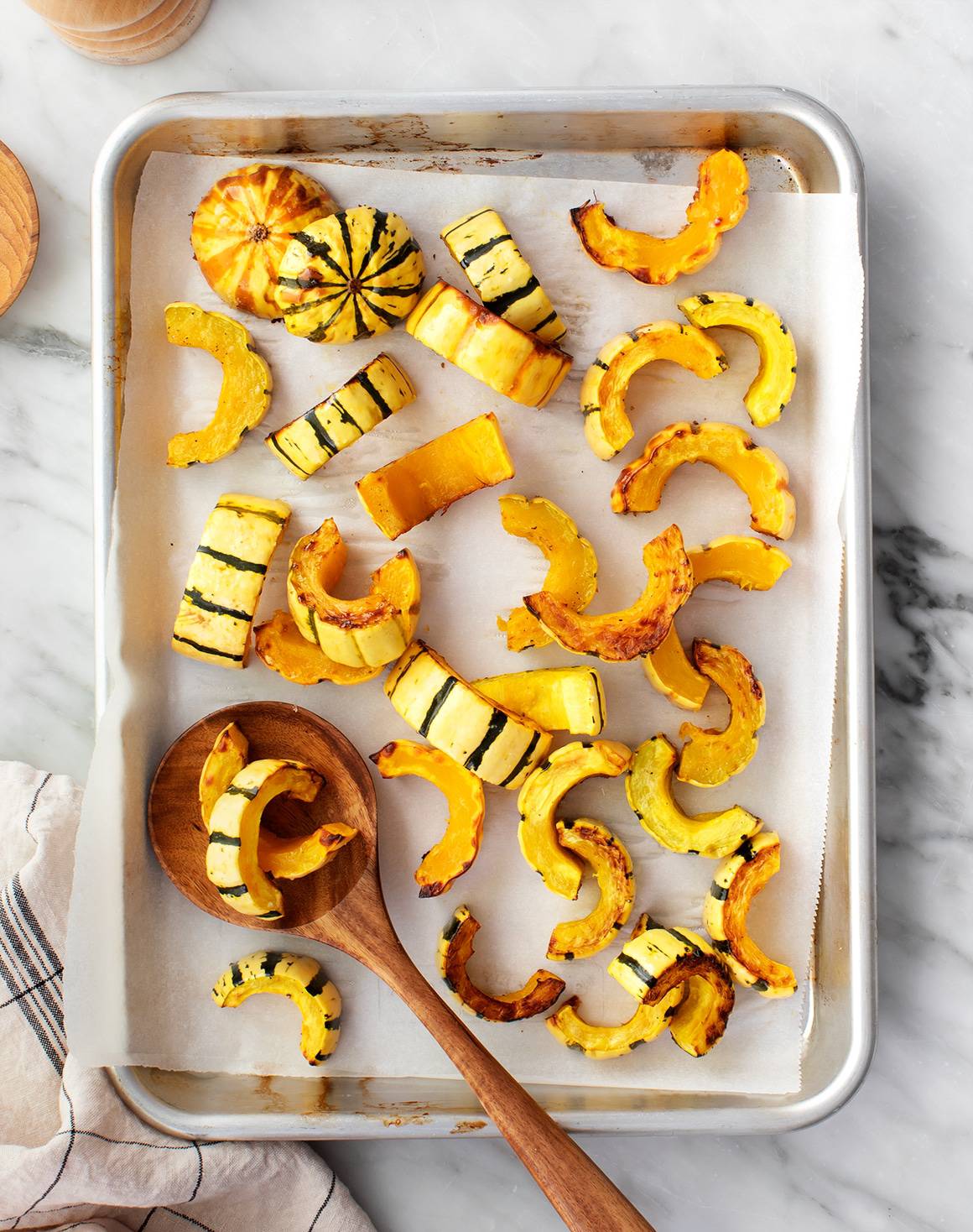 Roasted delicata squash on baking sheet