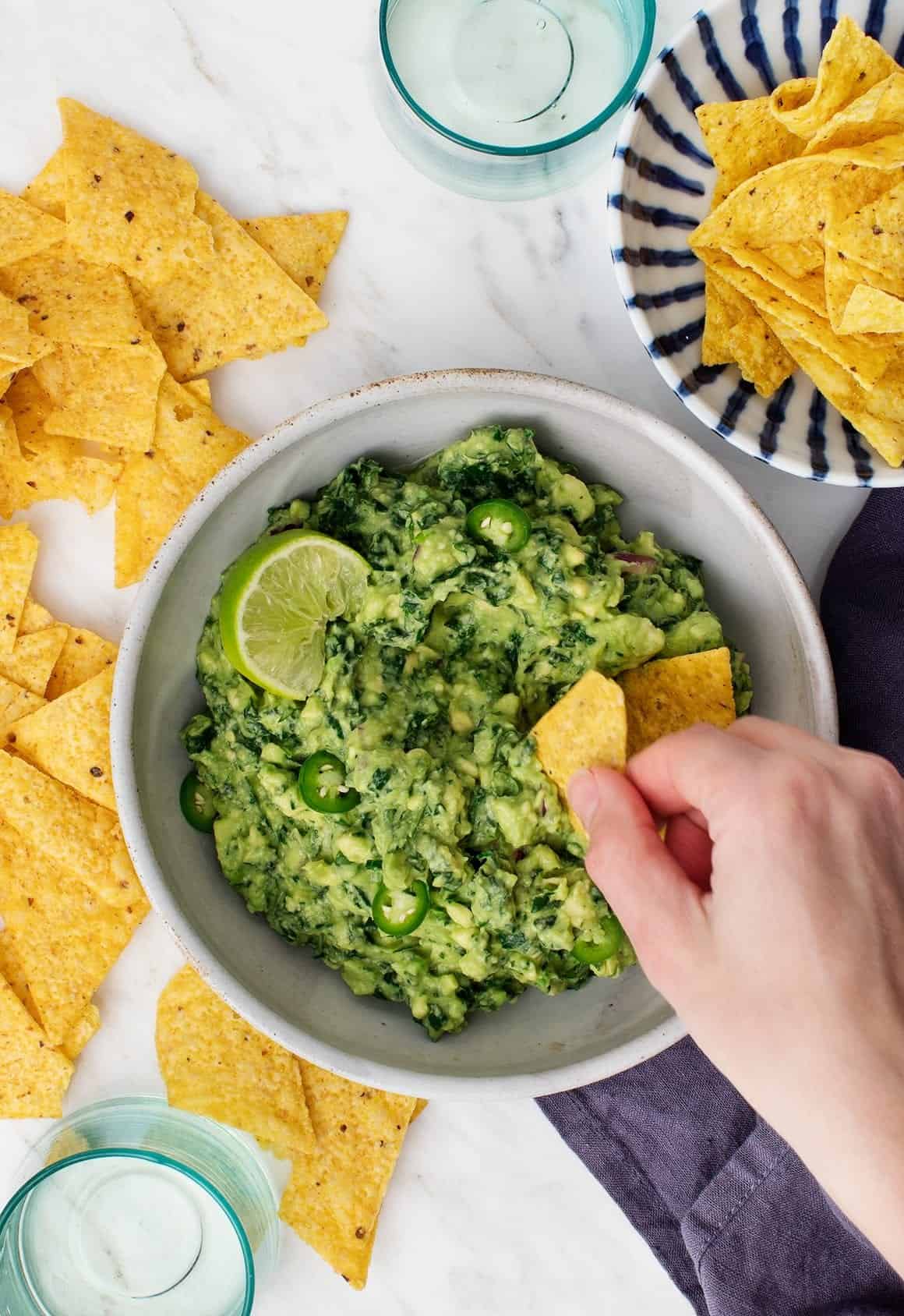 Kale Guacamole in a bowl with chips