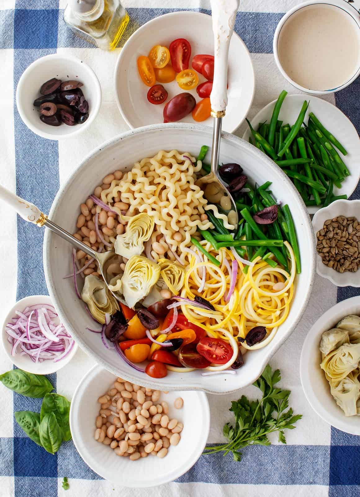 Pasta, veggies, and herbs in bowls