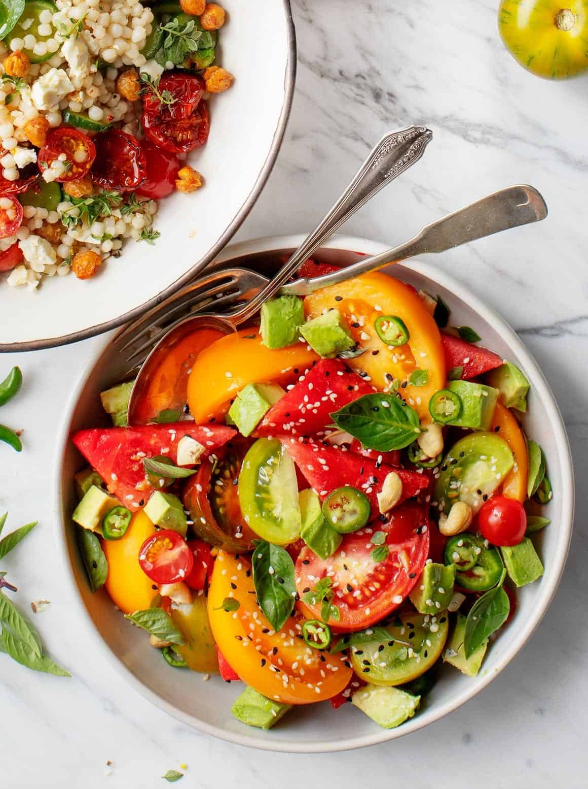 Spicy Watermelon Tomato Salad in a bowl with serving utensils