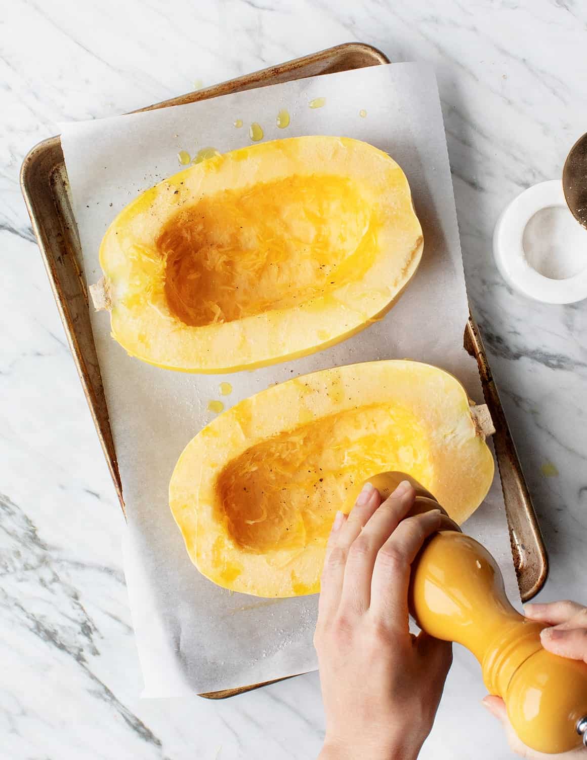 Spaghetti Squash on baking sheet with olive oil