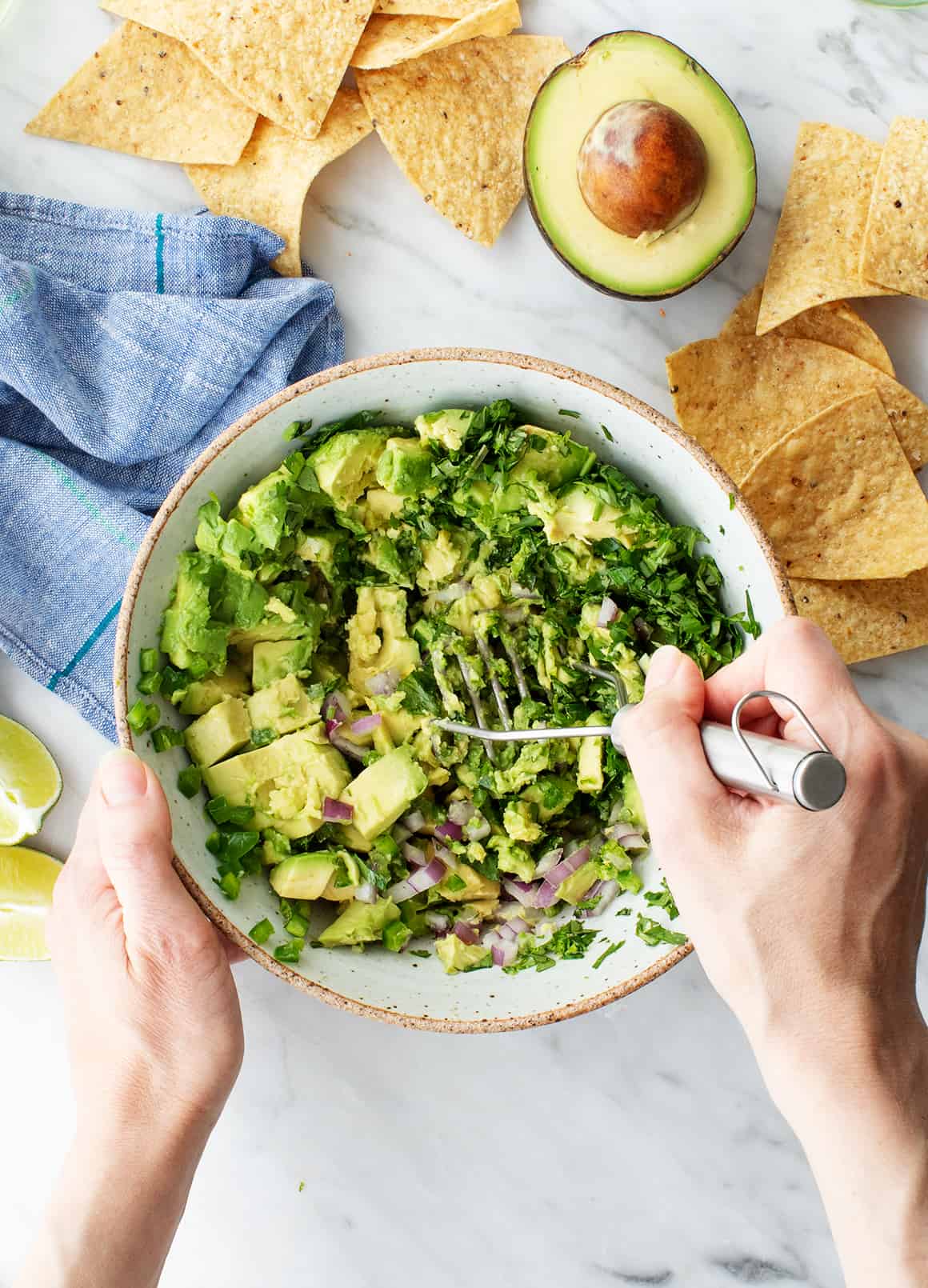 Mashing guacamole recipe ingredients in a bowl