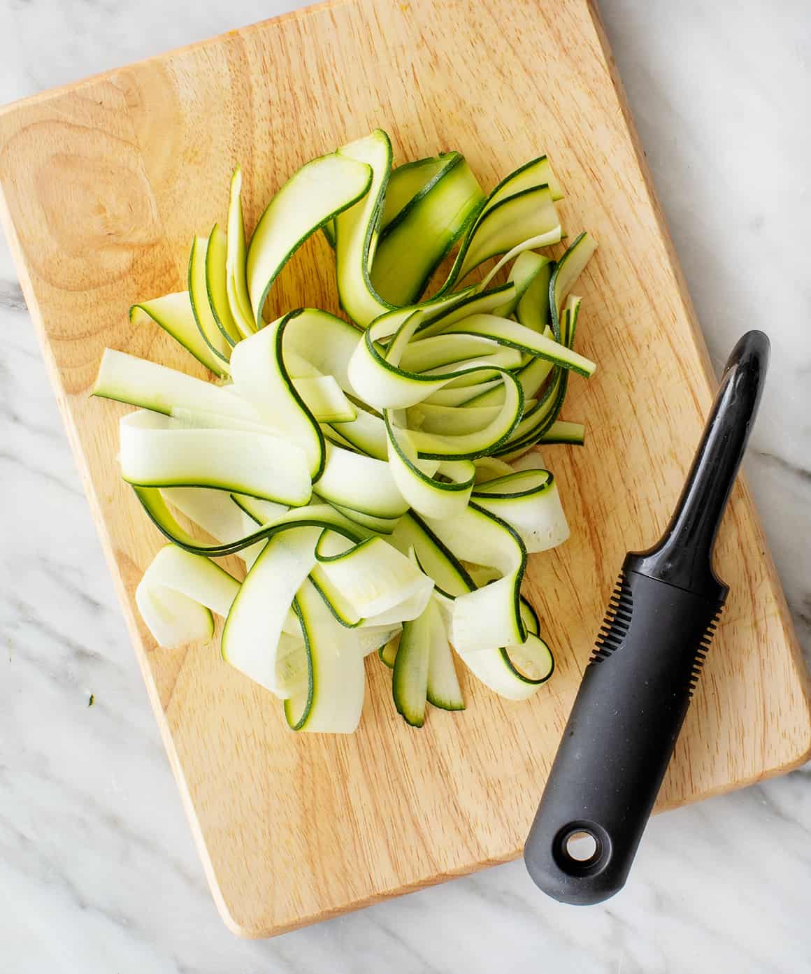 Making zucchini noodles with spiral vegetable slicer Stock Photo