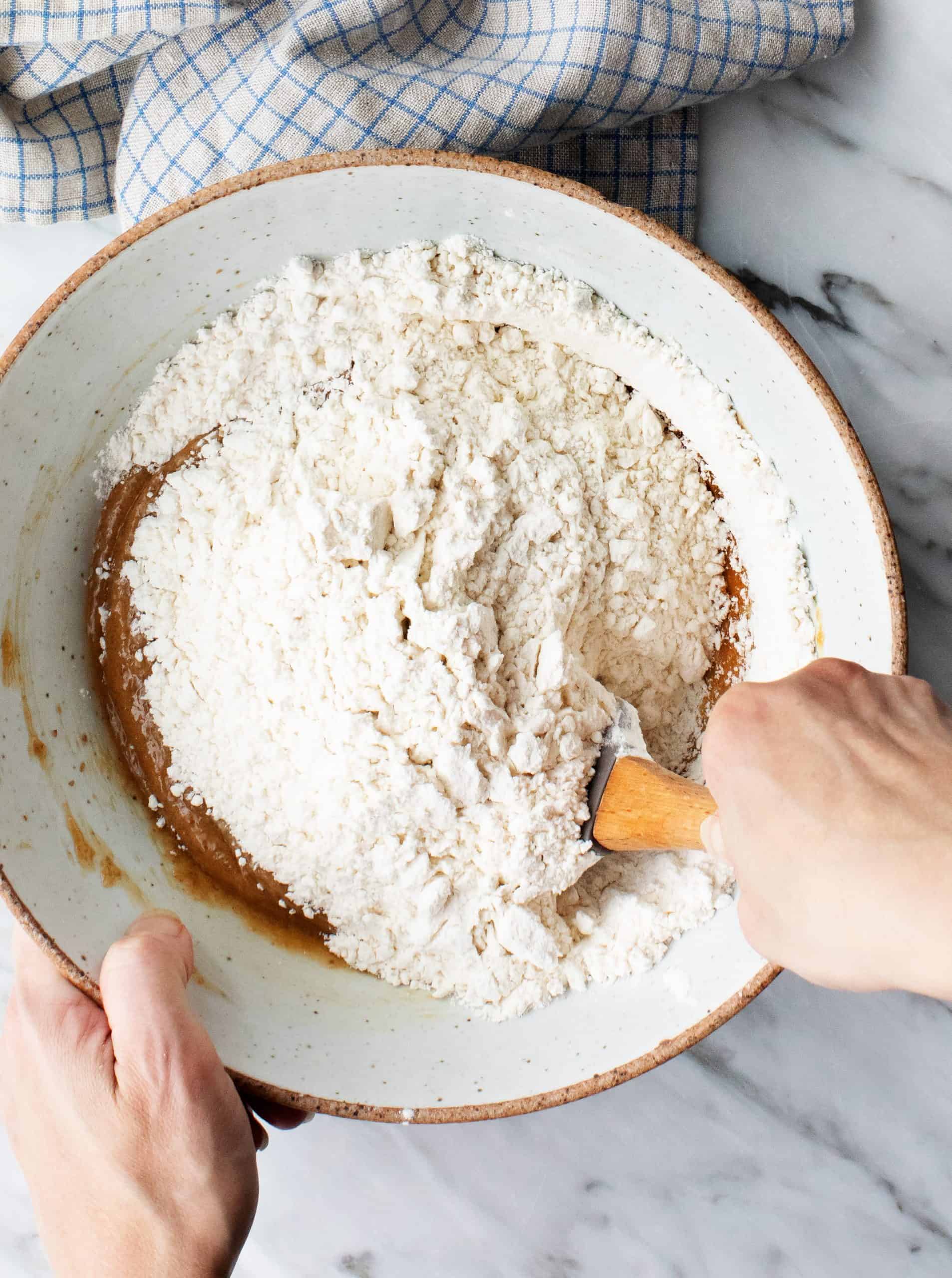 Mixing wet and dry ingredients for vegan peanut butter cookies