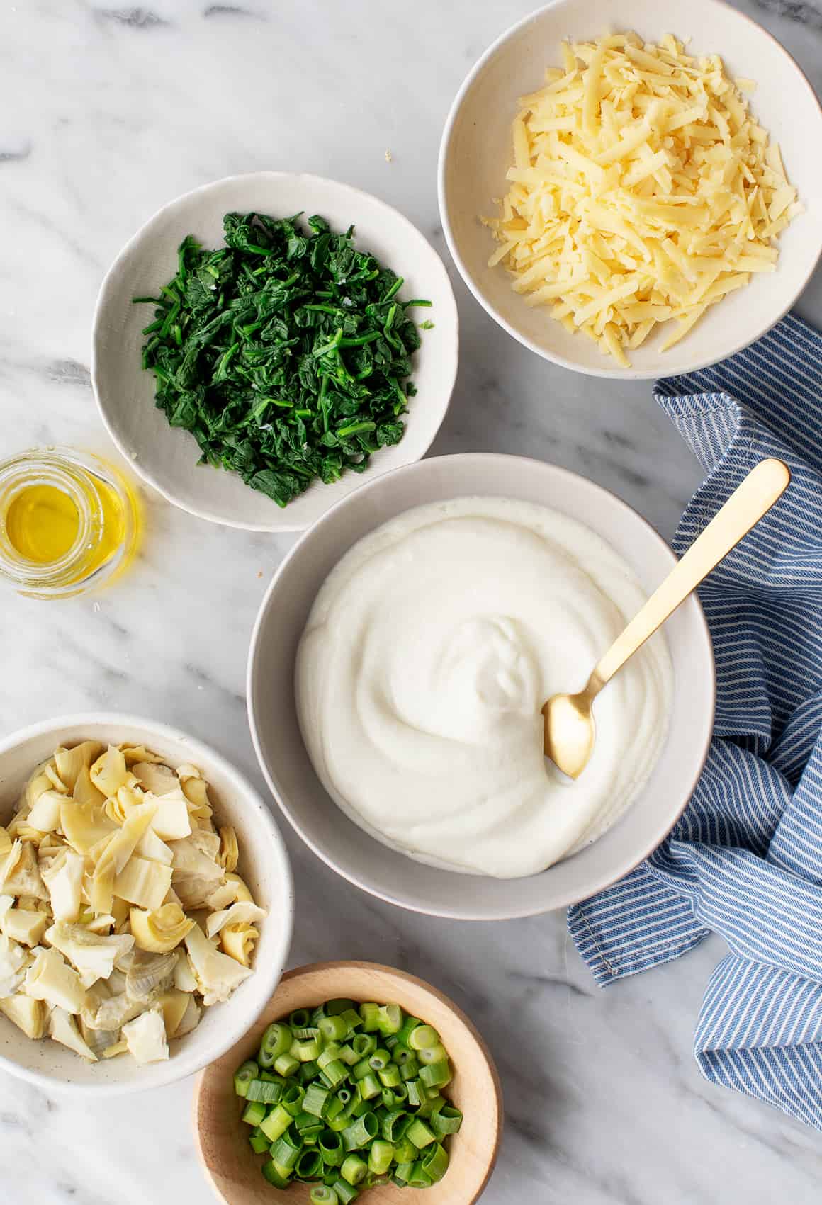 Spinach artichoke dip components in bowls