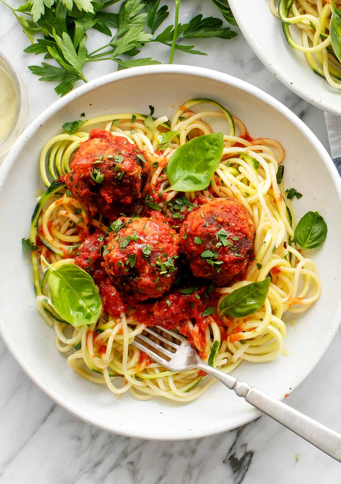 Spaghetti and meatballs on a plate with fork