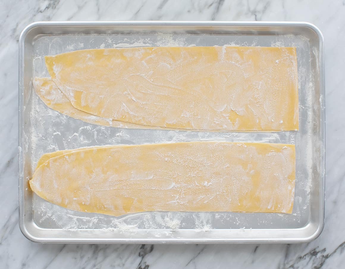 Homemade pasta dough on a baking sheet