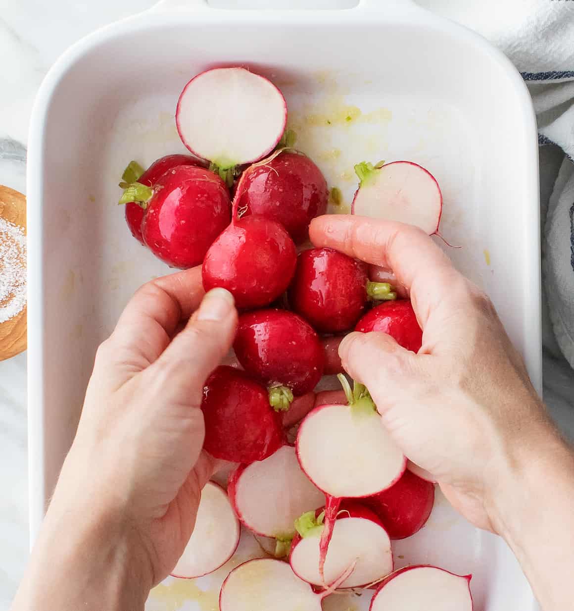 Tossing radishes with olive oil