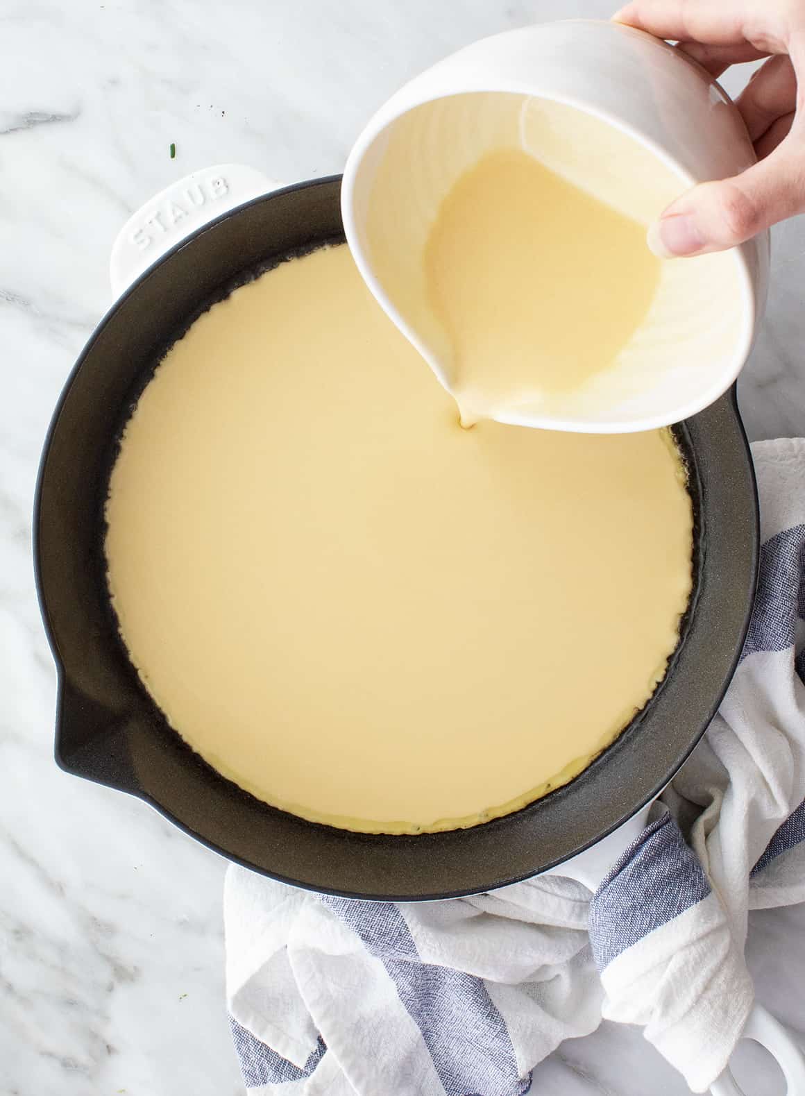 Farinata batter in a cast-iron skillet