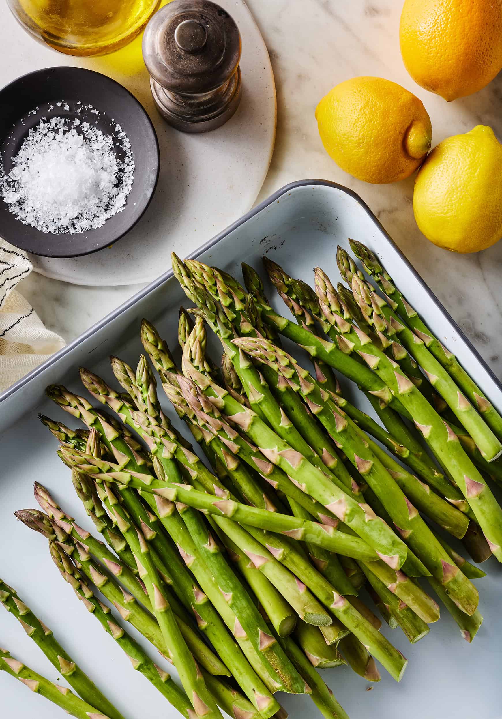 Recipe ingredients - asparagus, lemons, olive oil, salt, and pepper