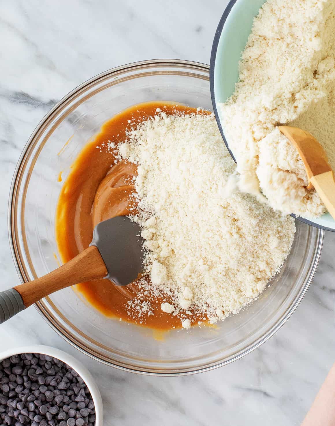 Adding almond flour to bowl of wet ingredients