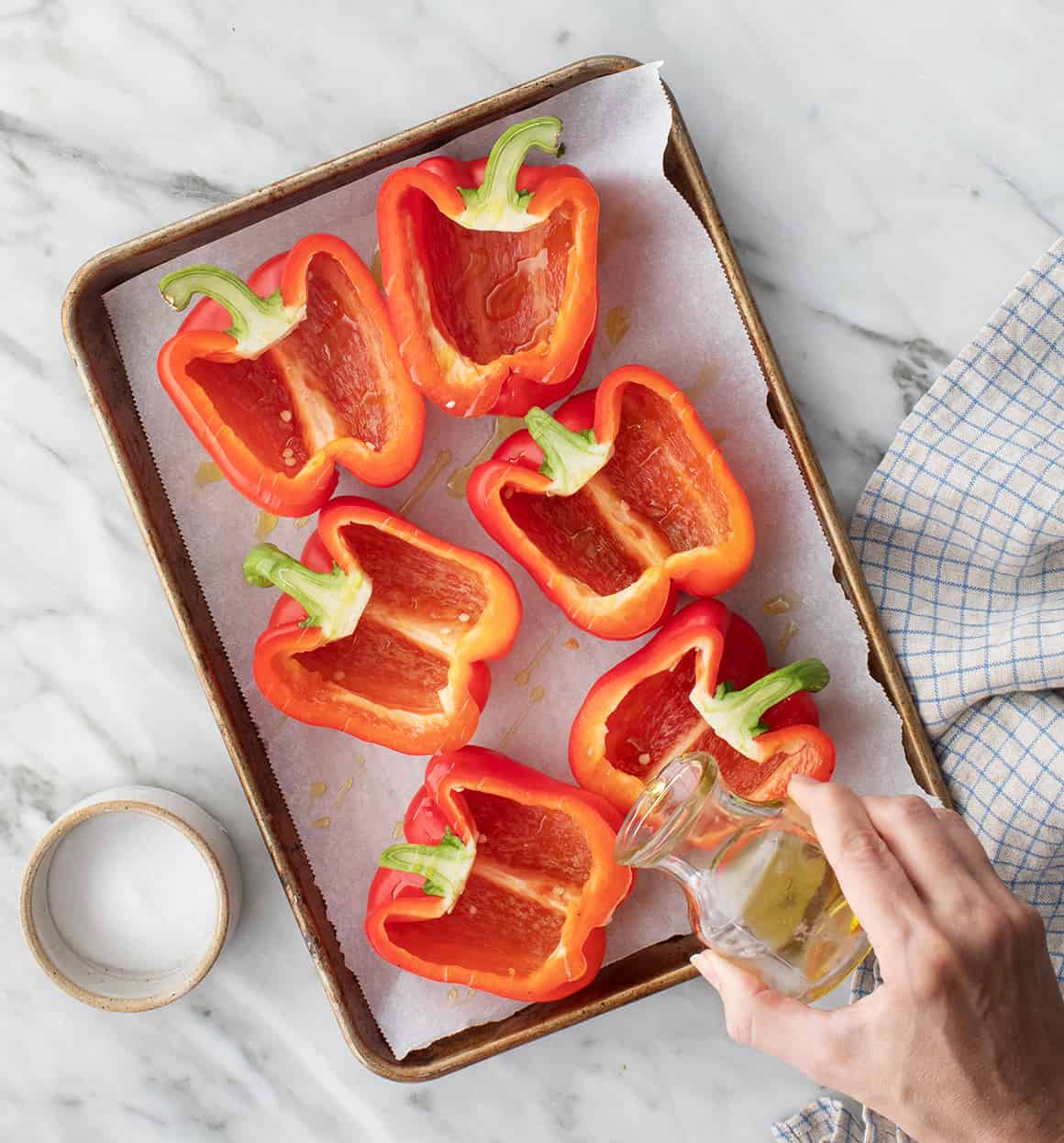 Red bell peppers on a baking sheet