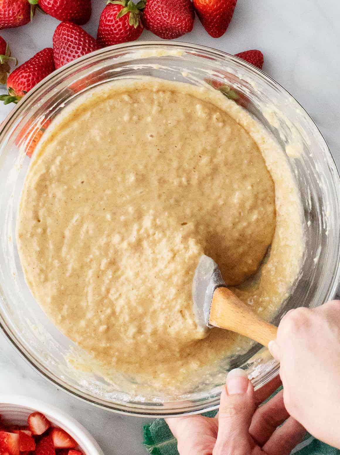 Hand mixing batter with rubber spatula