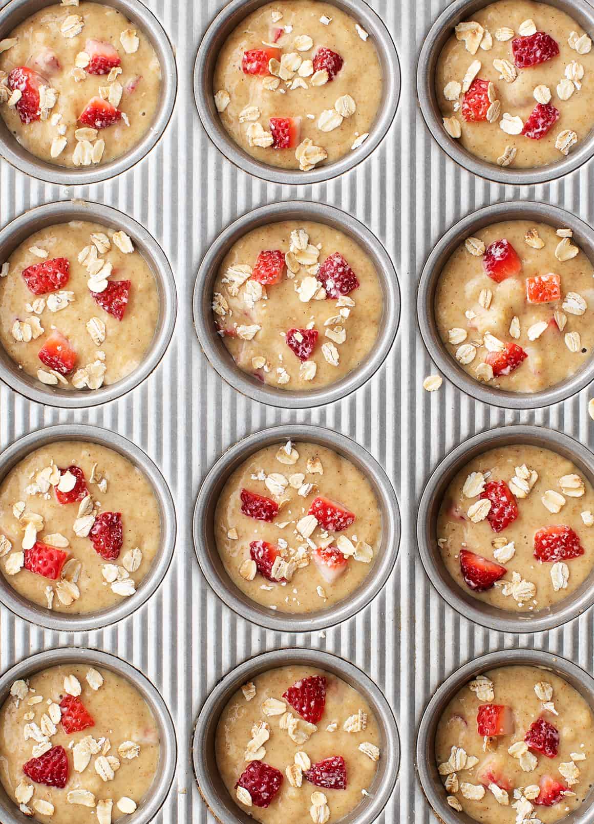 strawberry muffin batter in a tin