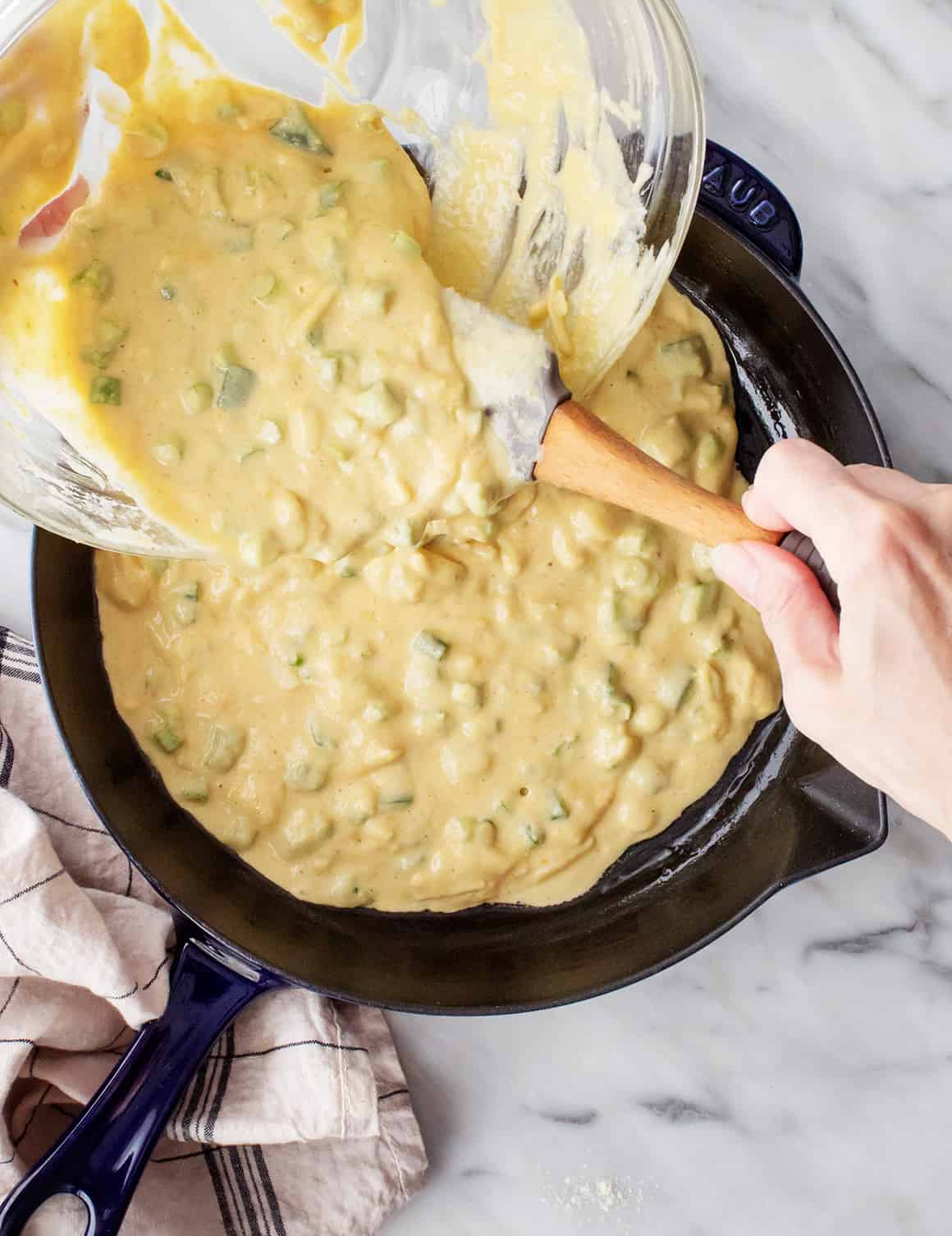 Pouring jalapeno cheddar cornbread batter into skillet