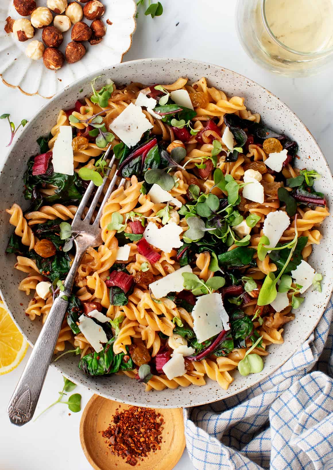 Bowl of pasta with Swiss chard, microgreens, and pecorino cheese