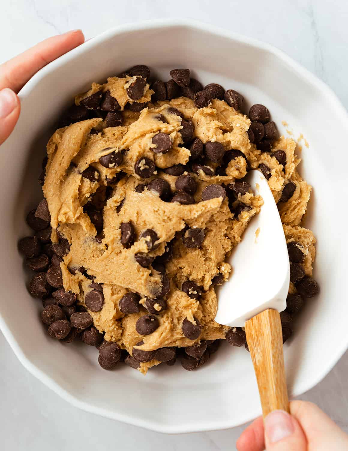 Hand mixing cookie dough with spatula