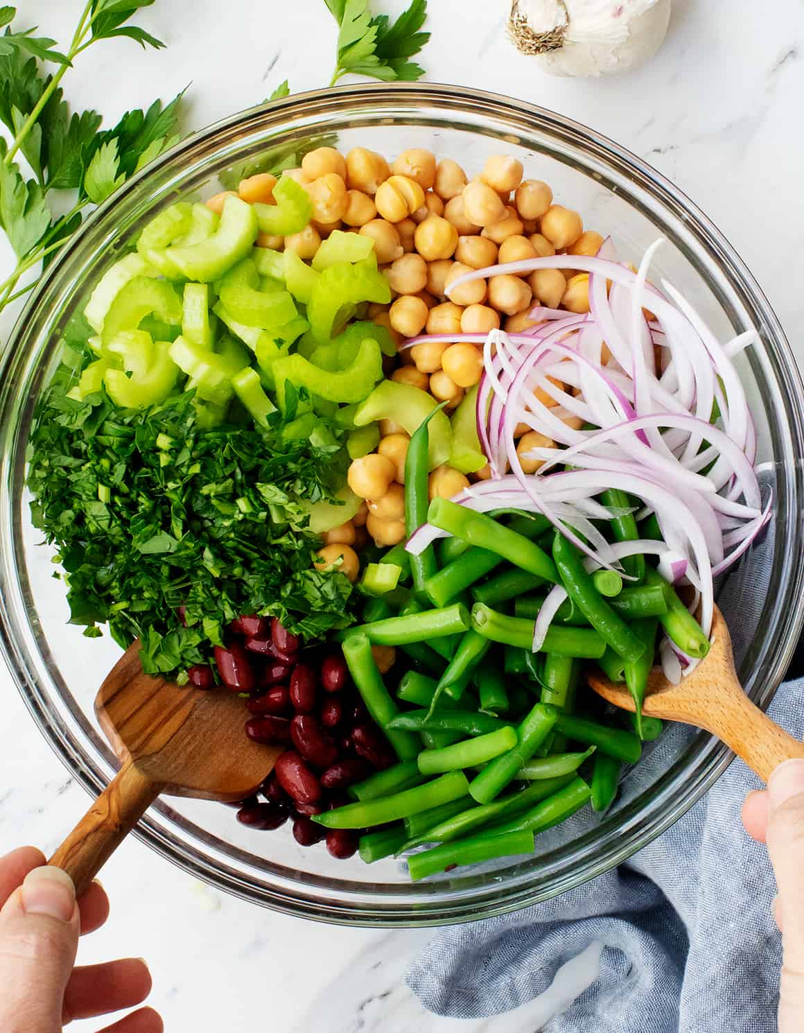Three bean salad recipe ingredients in a glass mixing bowl