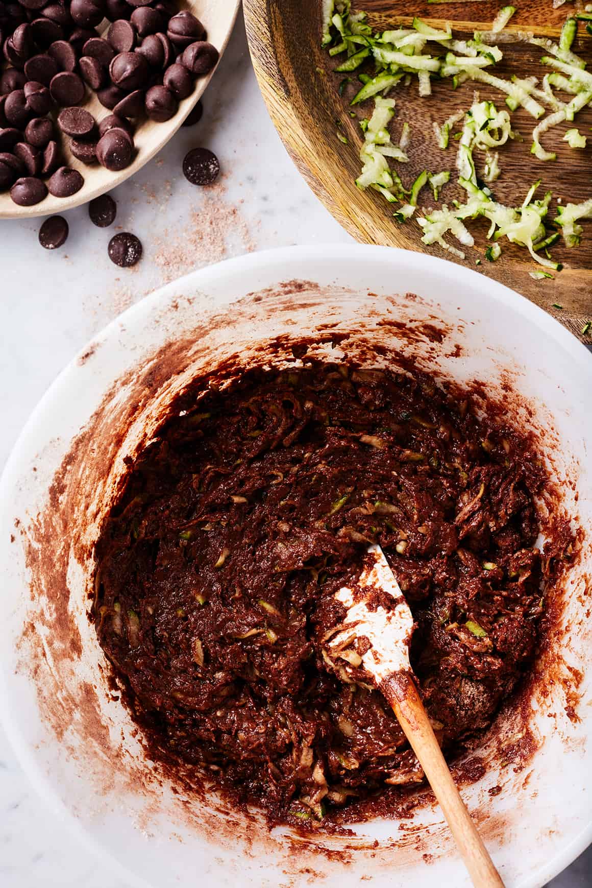 Batter for zucchini brownies in mixing bowl with spatula