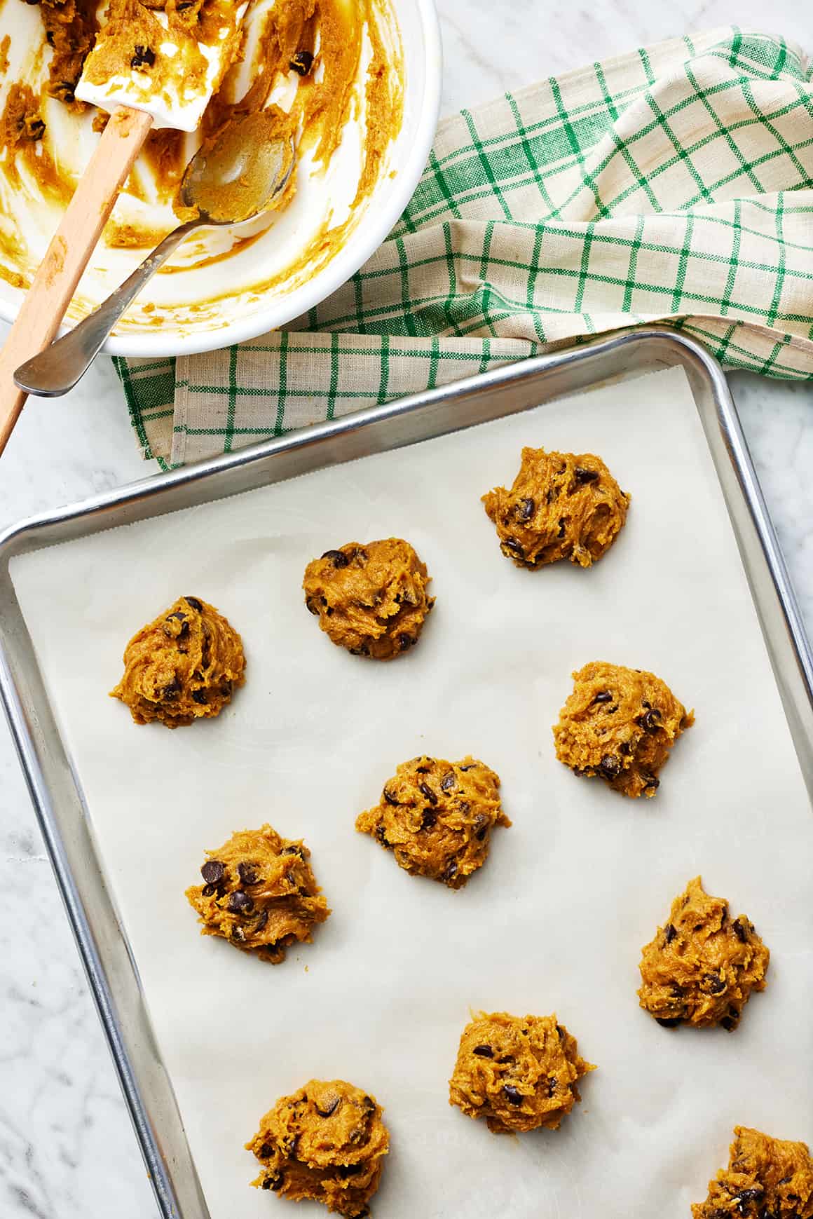 Chocolate chip pumpkin cookies dough balls on a baking sheet