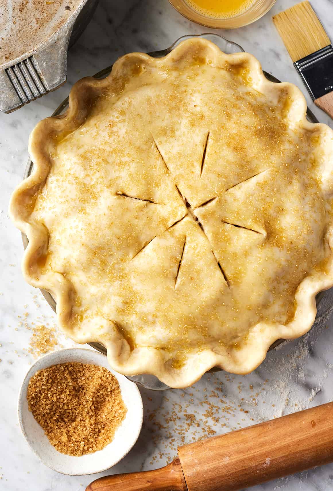 Unbaked apple pie topped with coarse sugar