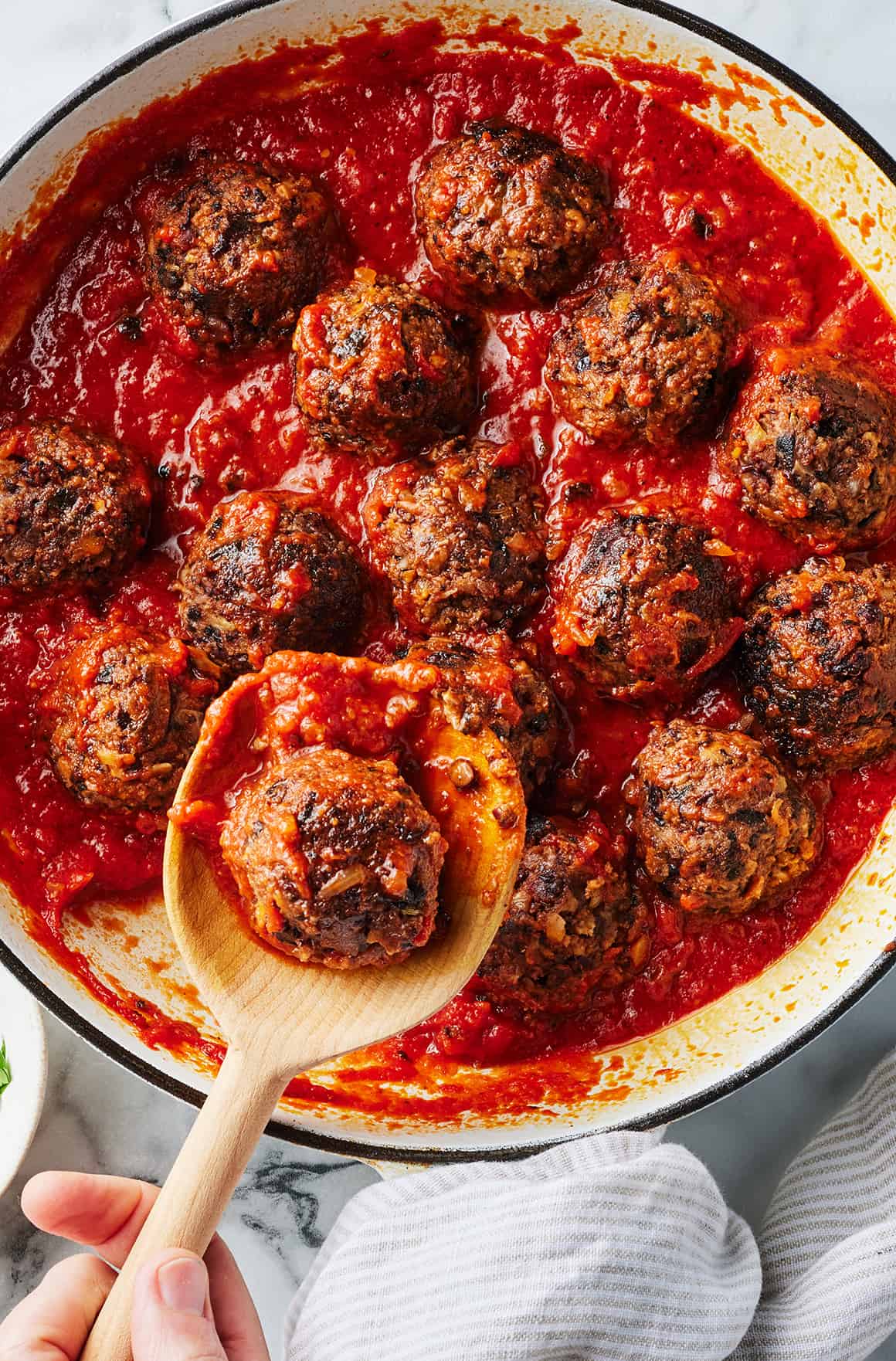 Vegan meatballs in marinara sauce in skillet