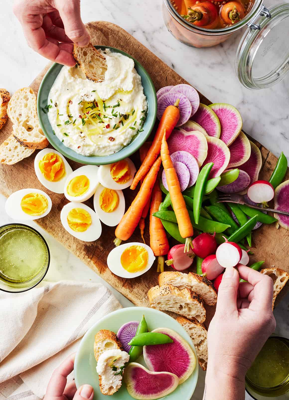 Appetizer board with whipped feta, spring veggies, and hard boiled egg