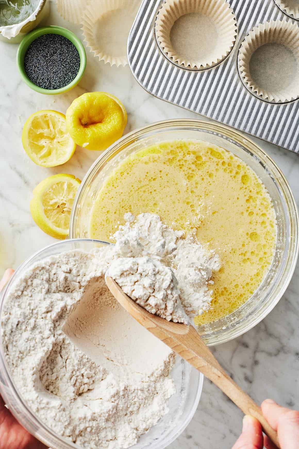 Pouring dry ingredients into wet ingredients