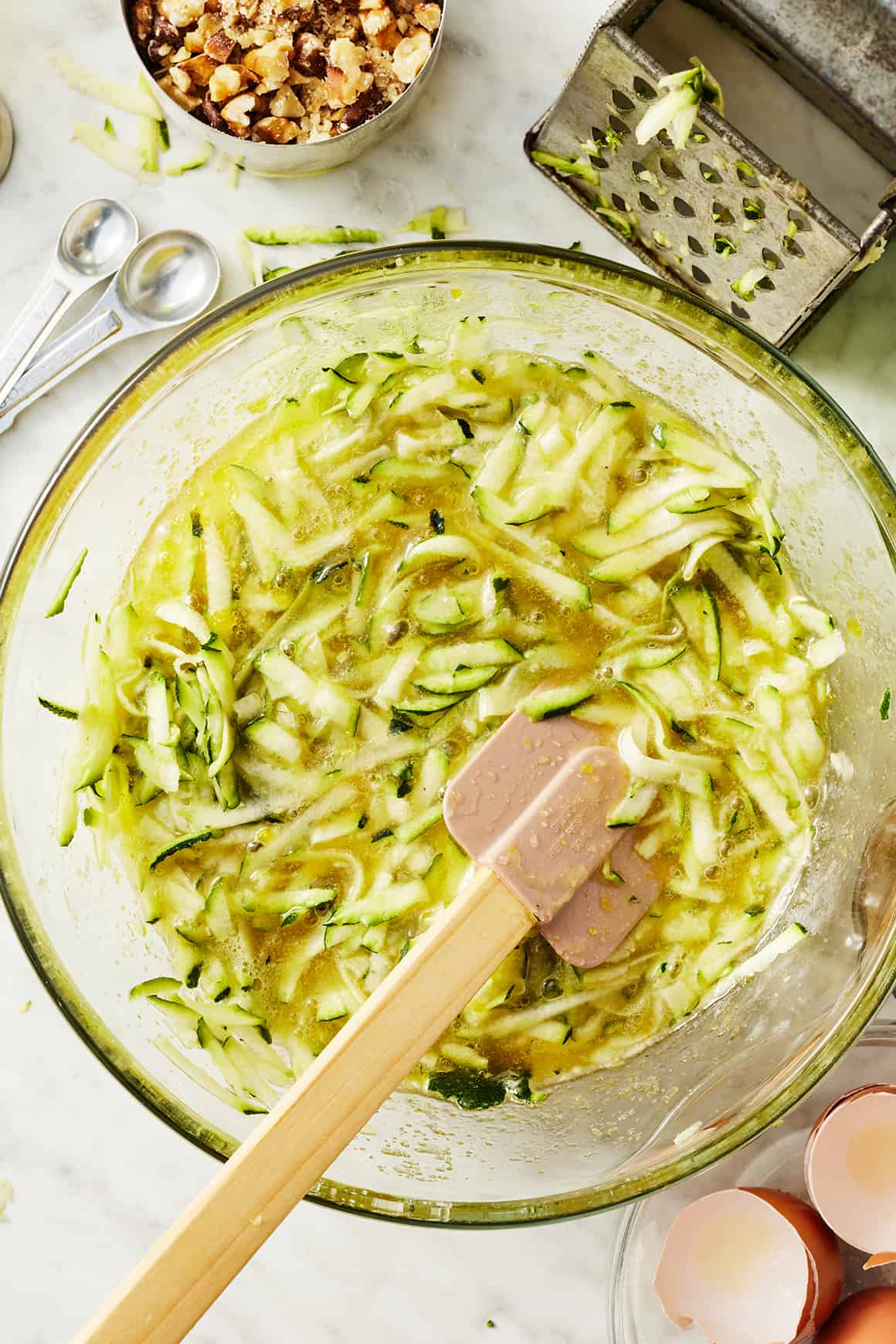 Wet ingredients in mixing bowl with rubber spatula
