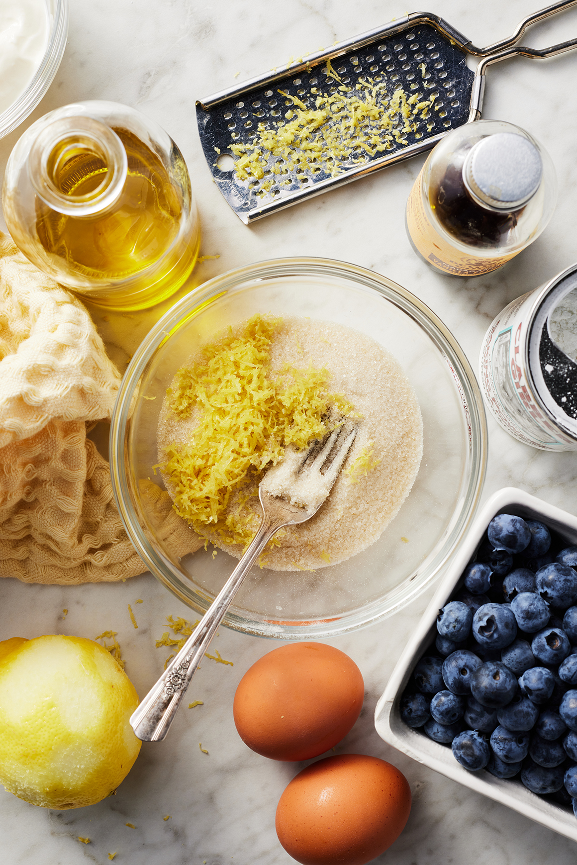 Lemon zest and cane sugar in bowl with fork