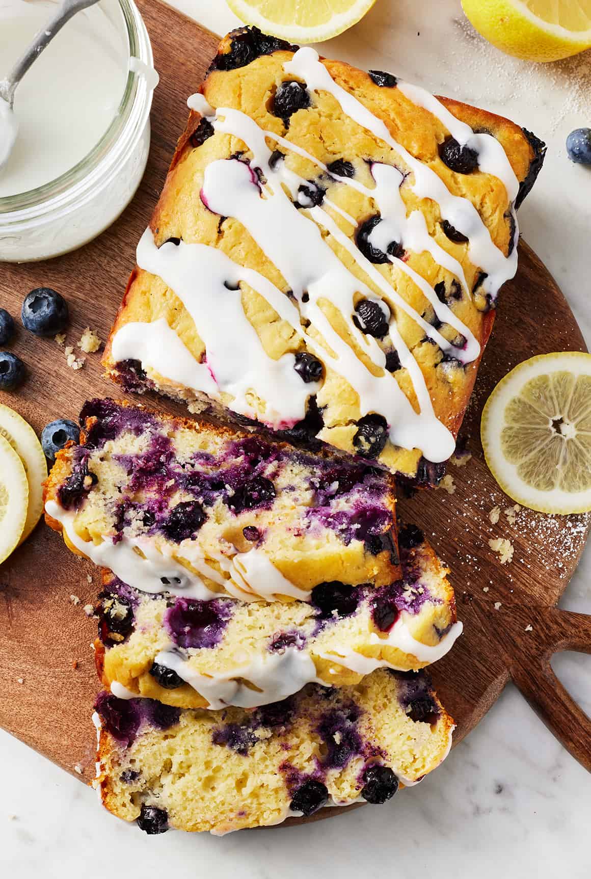 Sliced lemon blueberry bread on cutting board