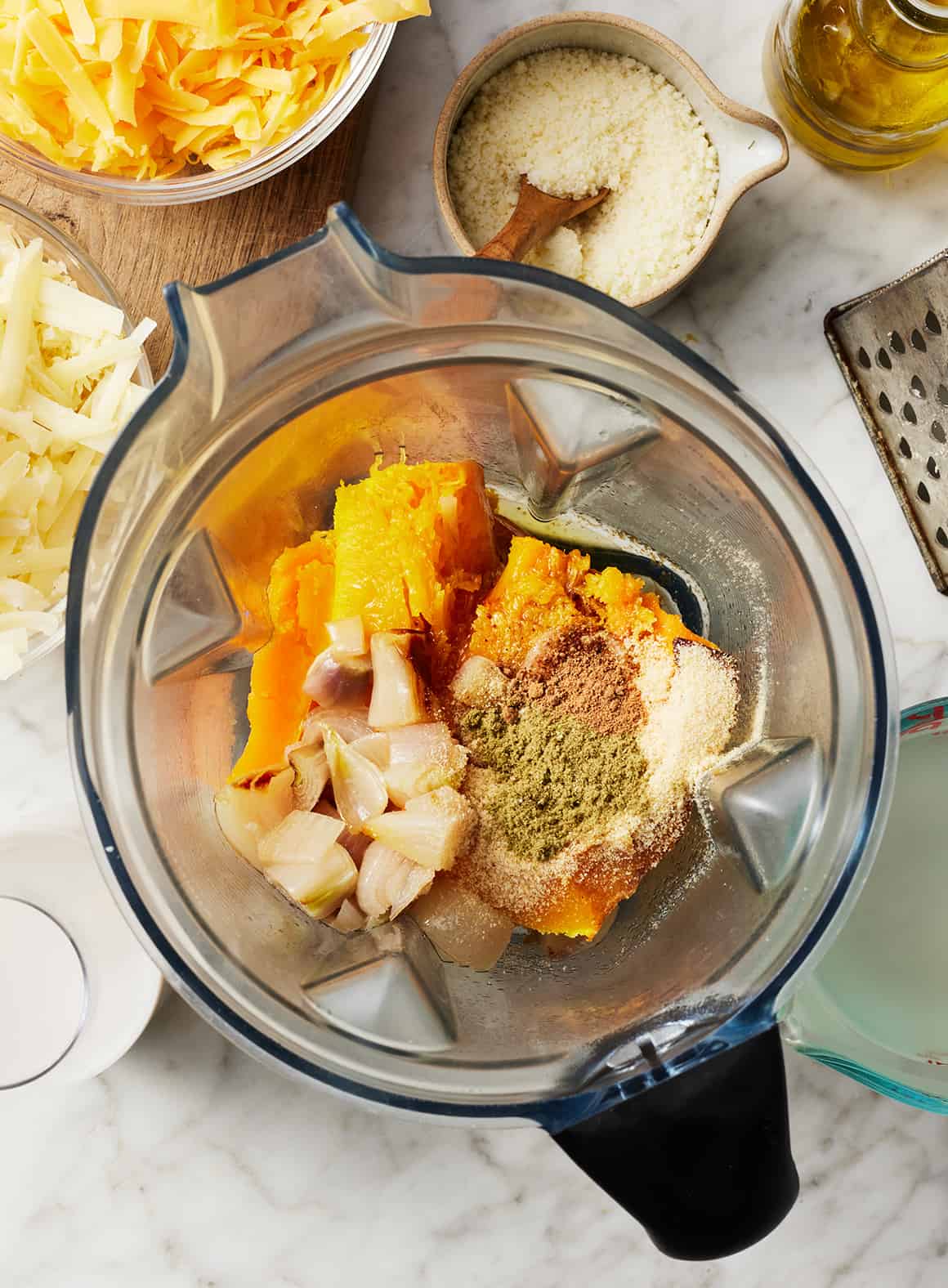 Roasted squash, shallots, and spices in a blender