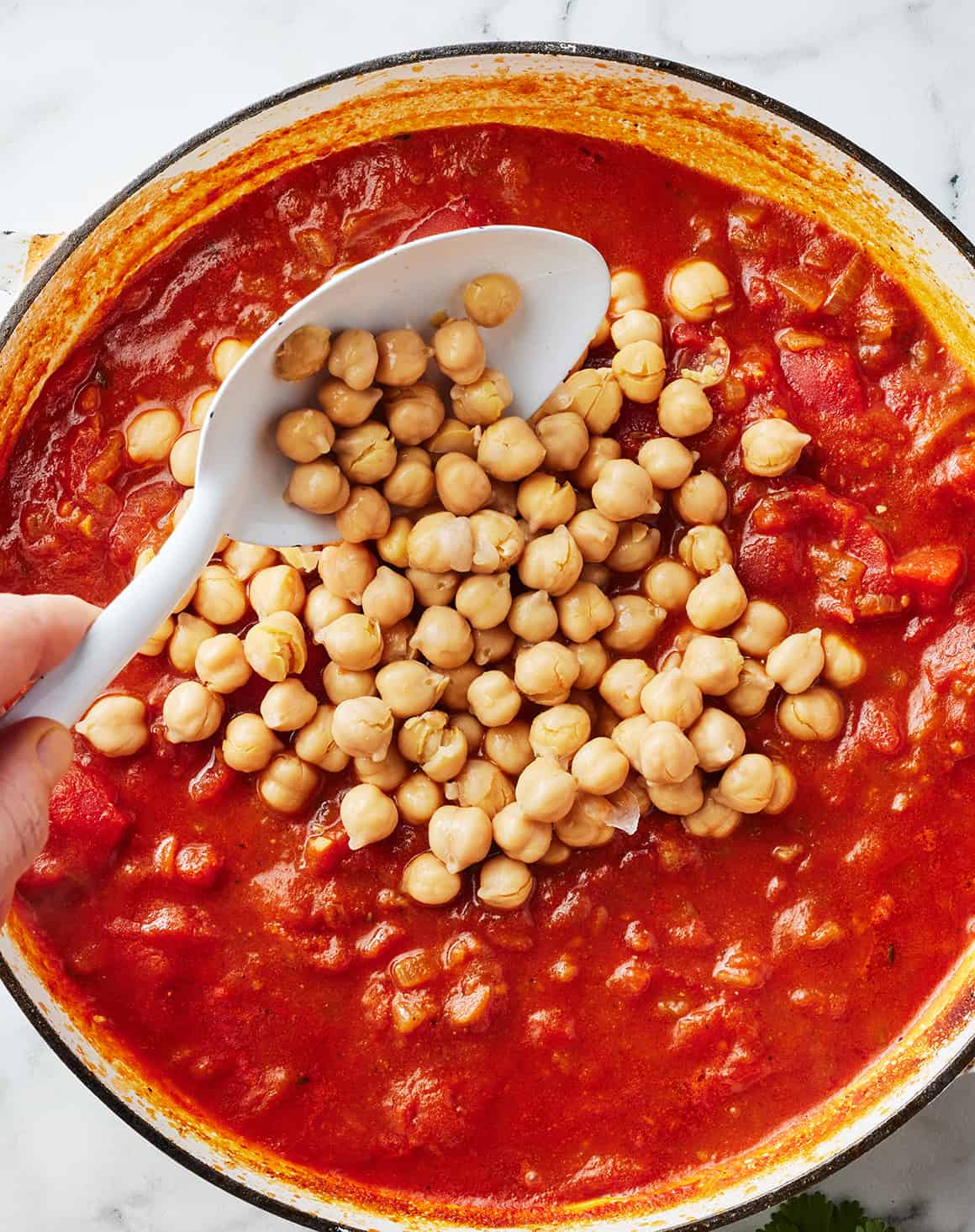 Adding chickpeas to tomato and onion sauce