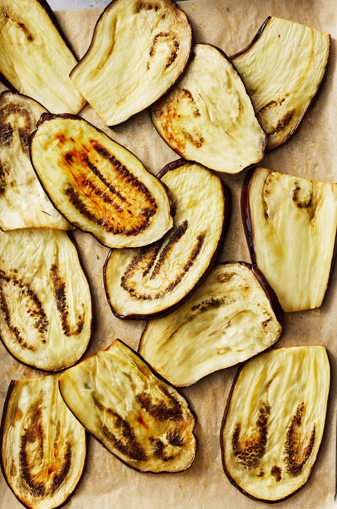 Roasted eggplant slices on baking sheet