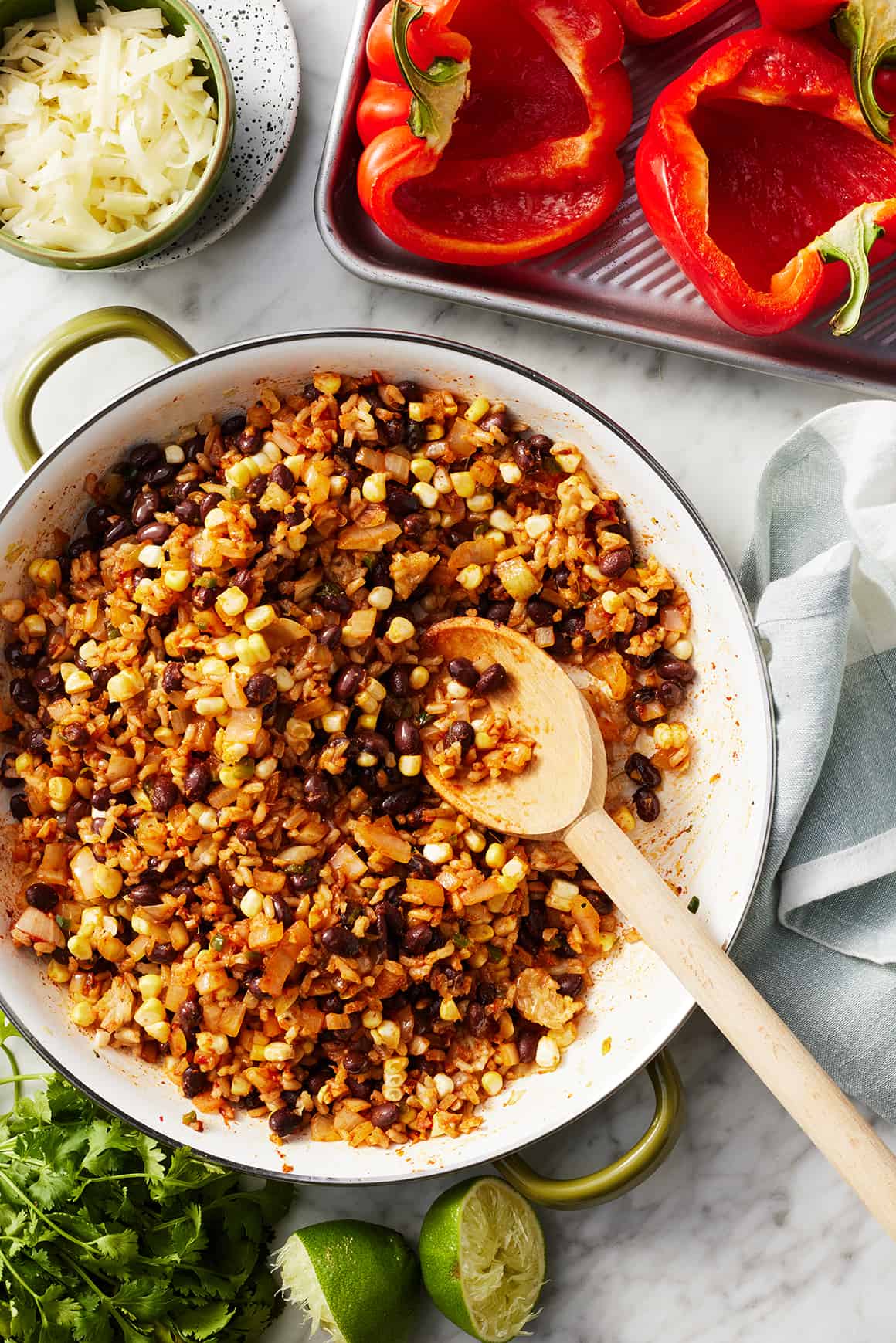 Rice and bean filling in skillet with wooden spoon