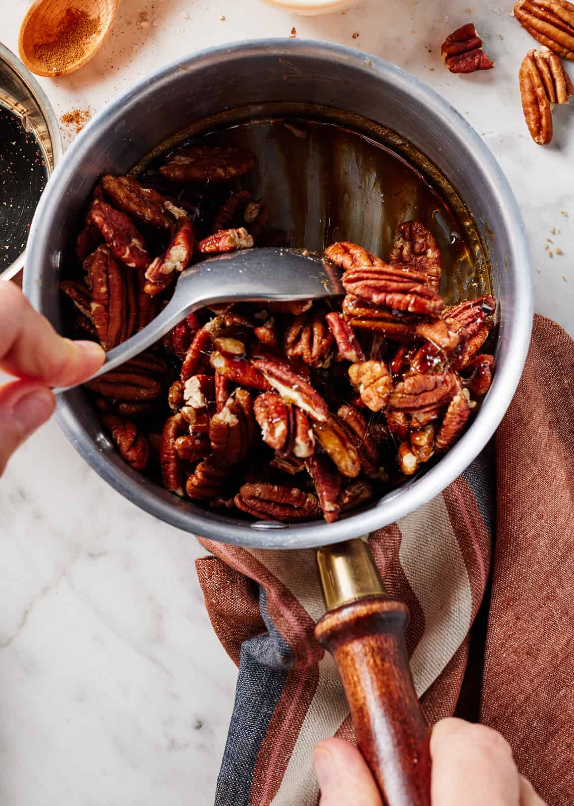 Stirring to coat nuts in brown sugar glaze
