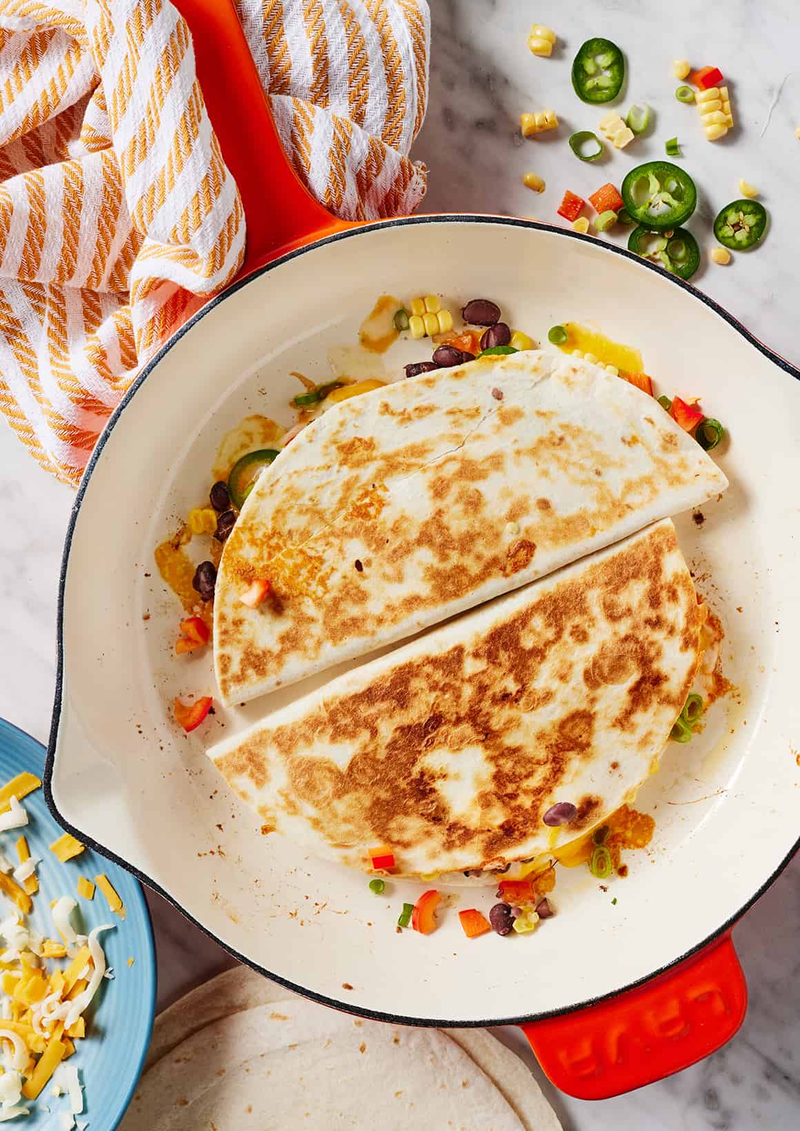 Quesadillas cooking in cast iron skillet