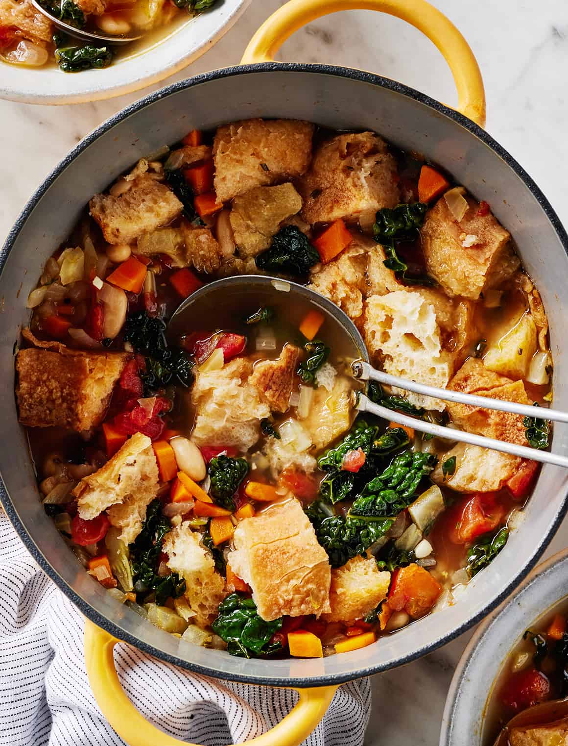 Ribollita (Tuscan white bean soup) in pot with ladle