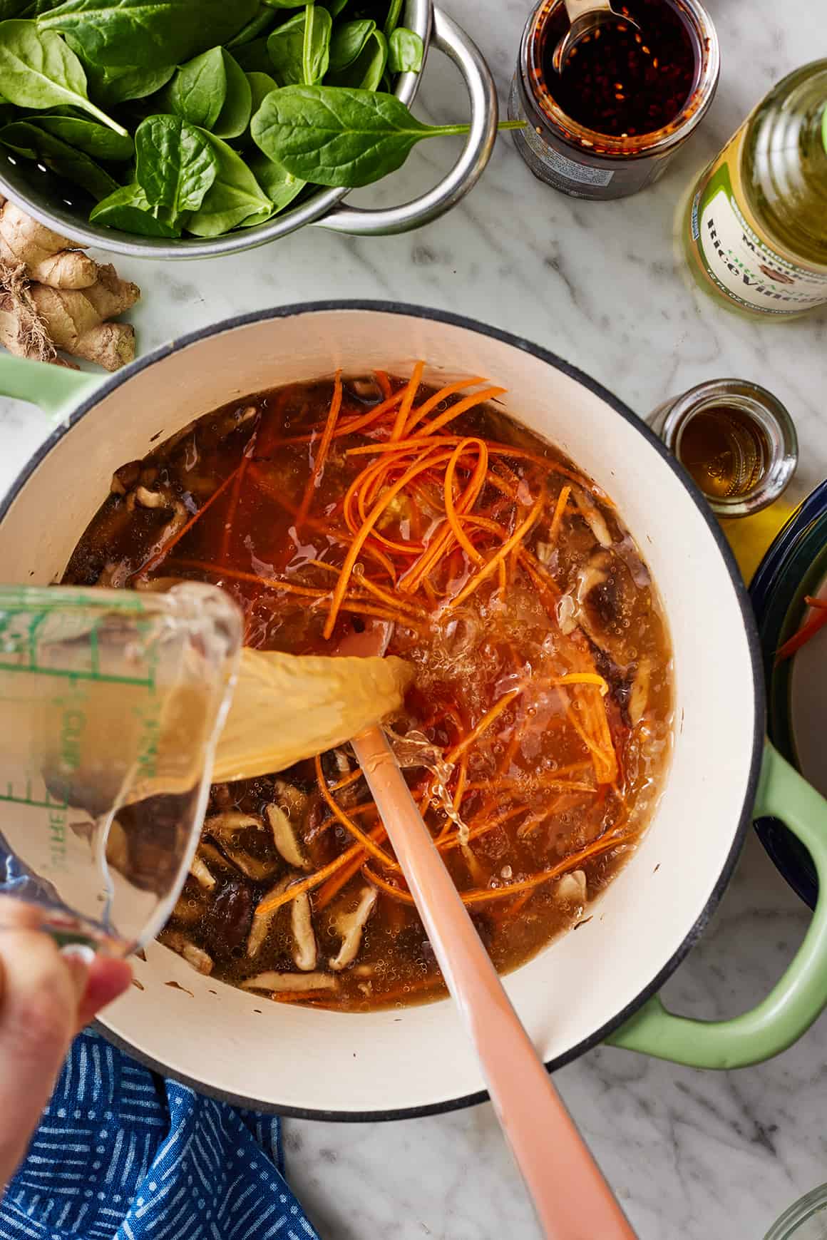 Pouring broth into soup pot