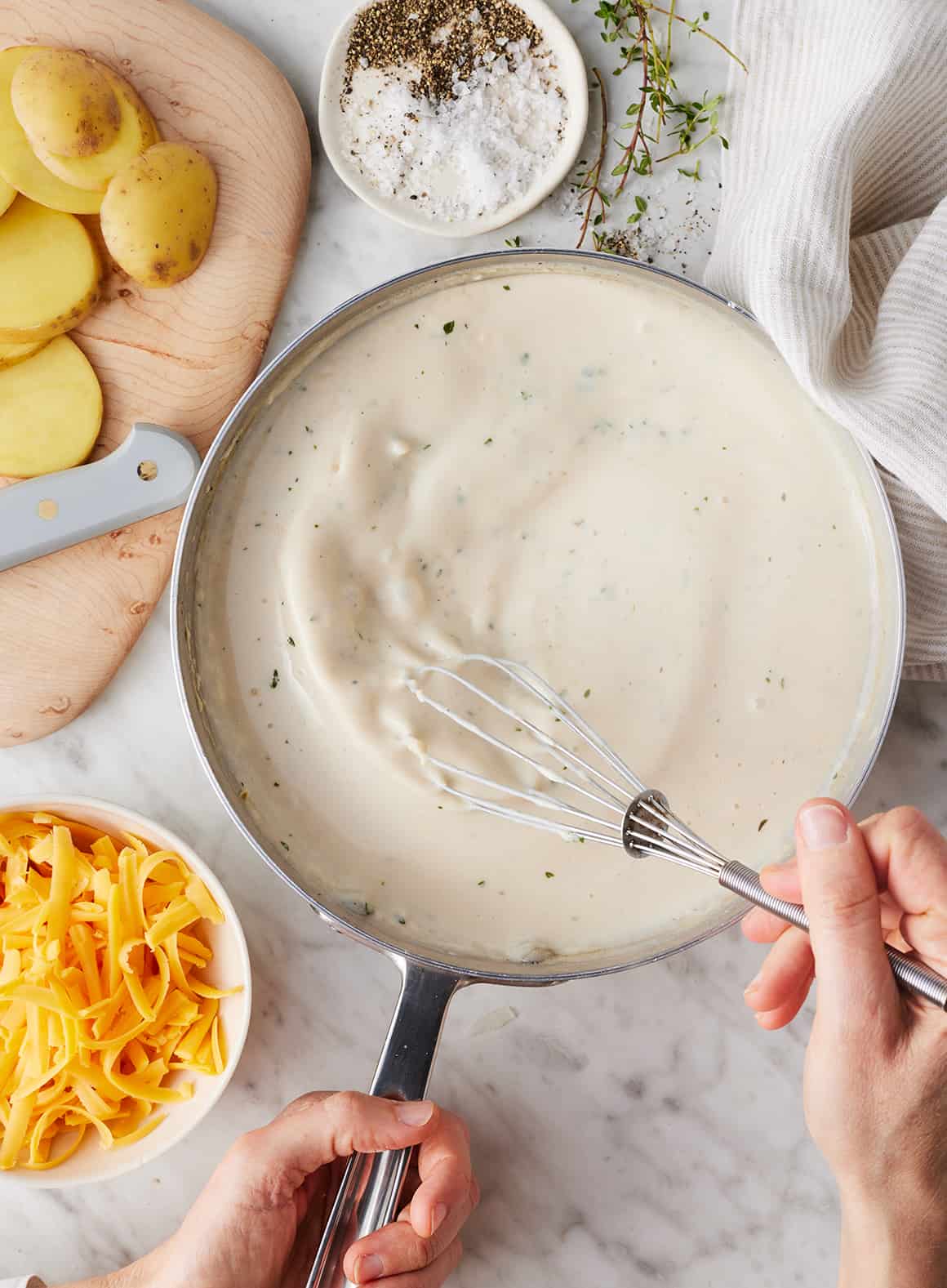 Whisking creamy sauce in skillet