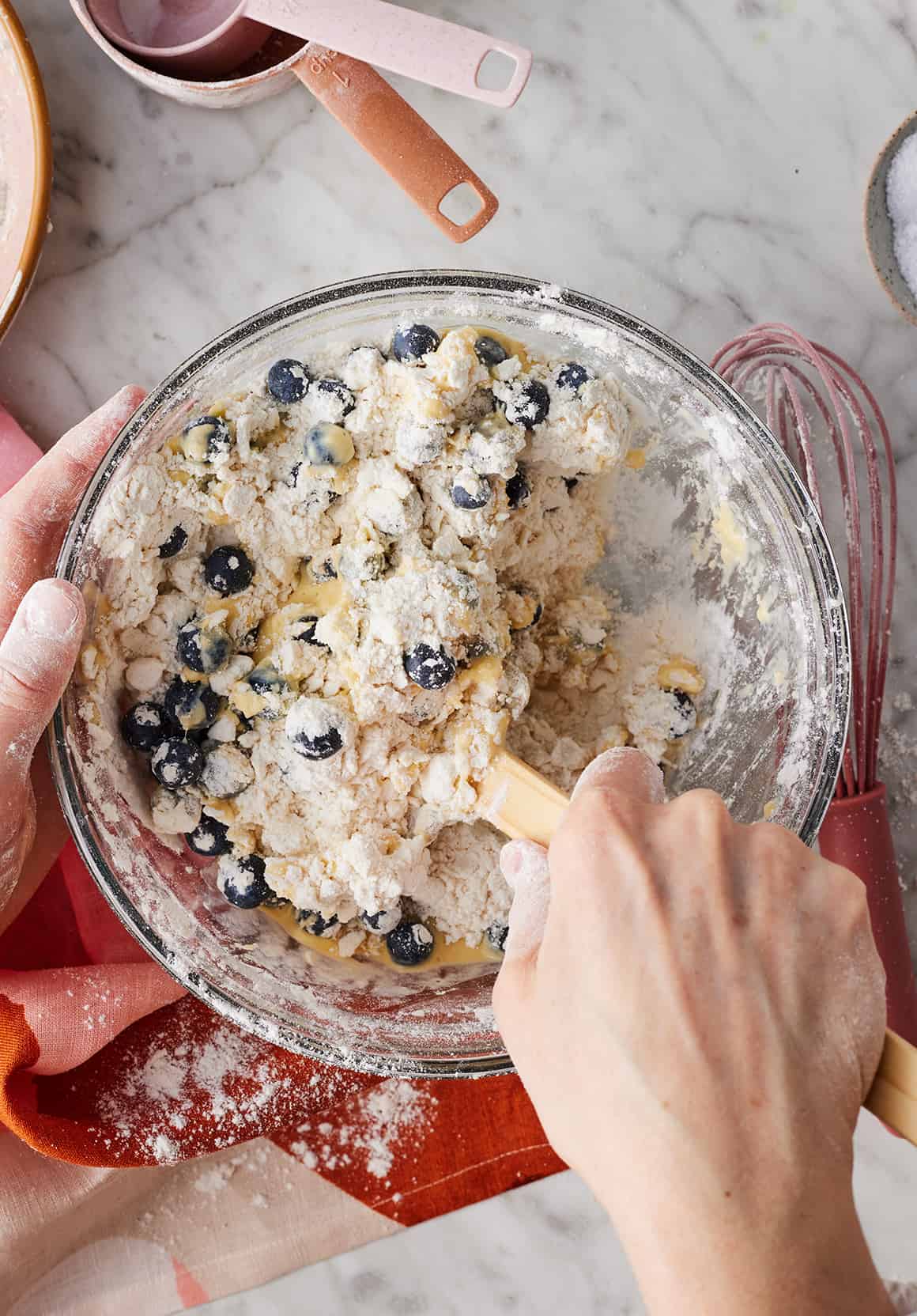 Mixing blueberry scone dough with spatula