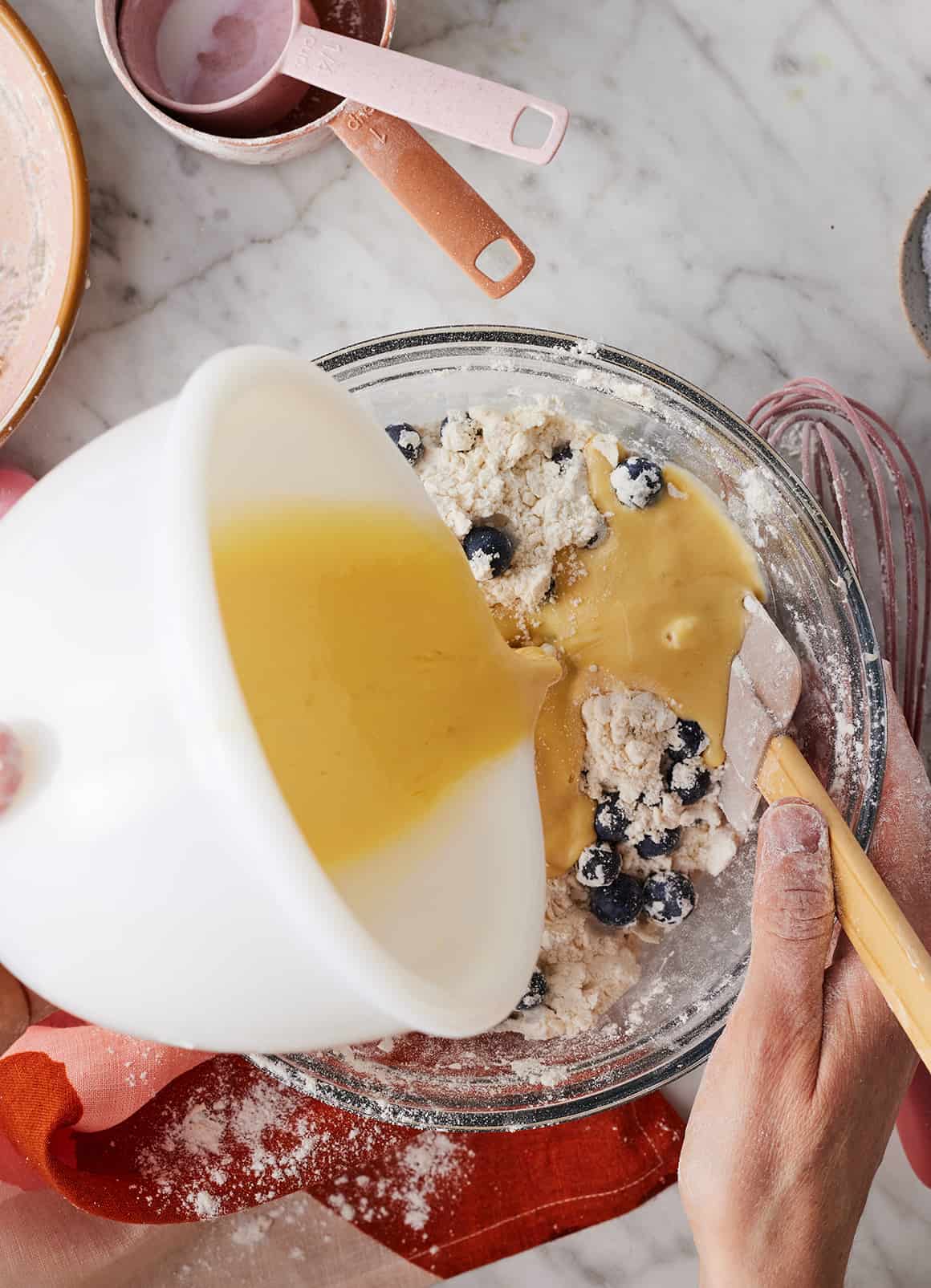 Adding wet ingredients to blueberry scone dough