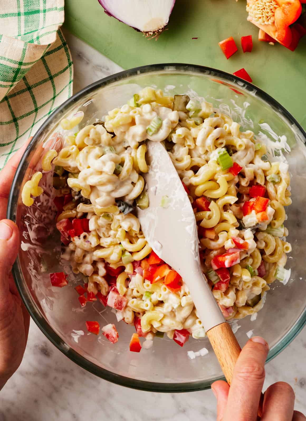 Mixing easy macaroni salad in glass bowl