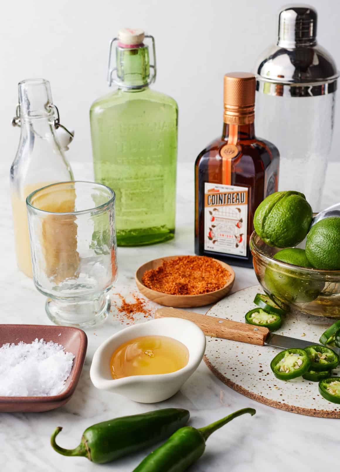 Recipe ingredients - jalapeños, limes, agave, Cointreau, tequila, Tajín, and salt