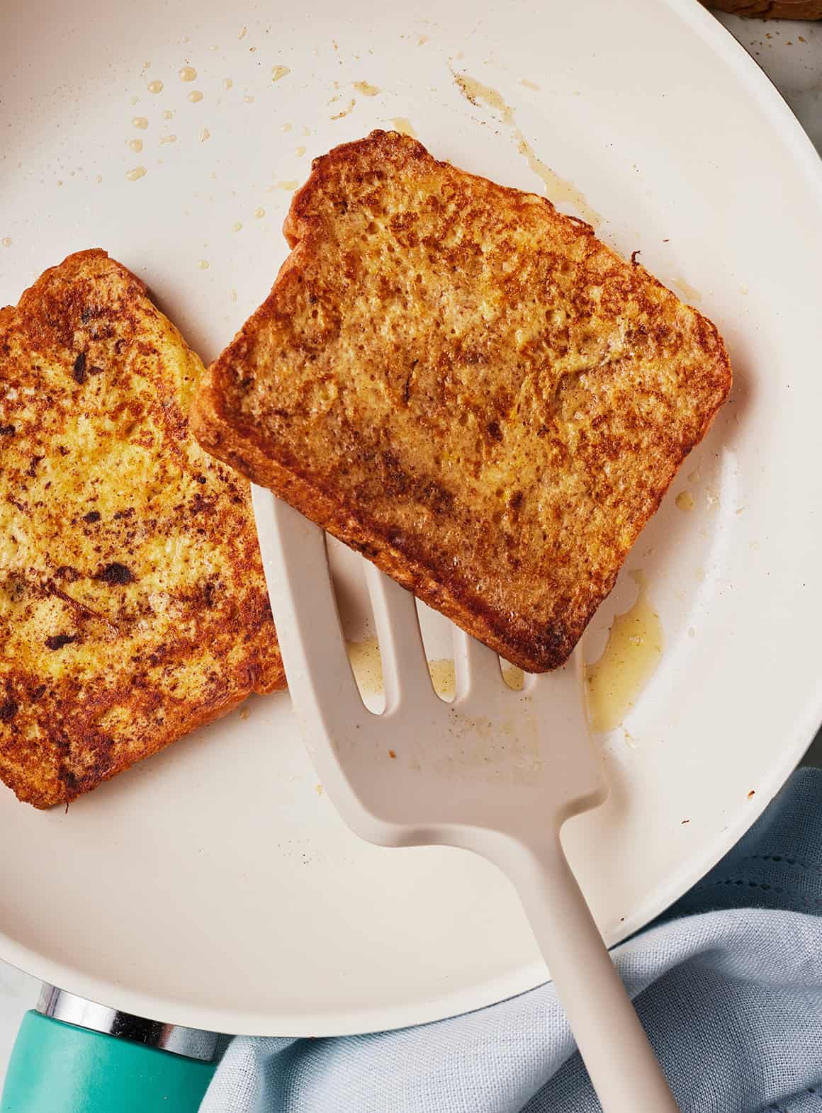 Flipping slice of French toast in skillet