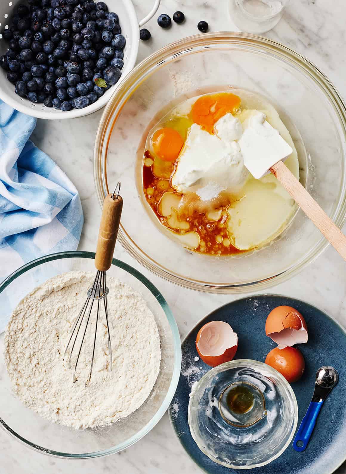 Two mixing bowls containing wet and dry ingredients
