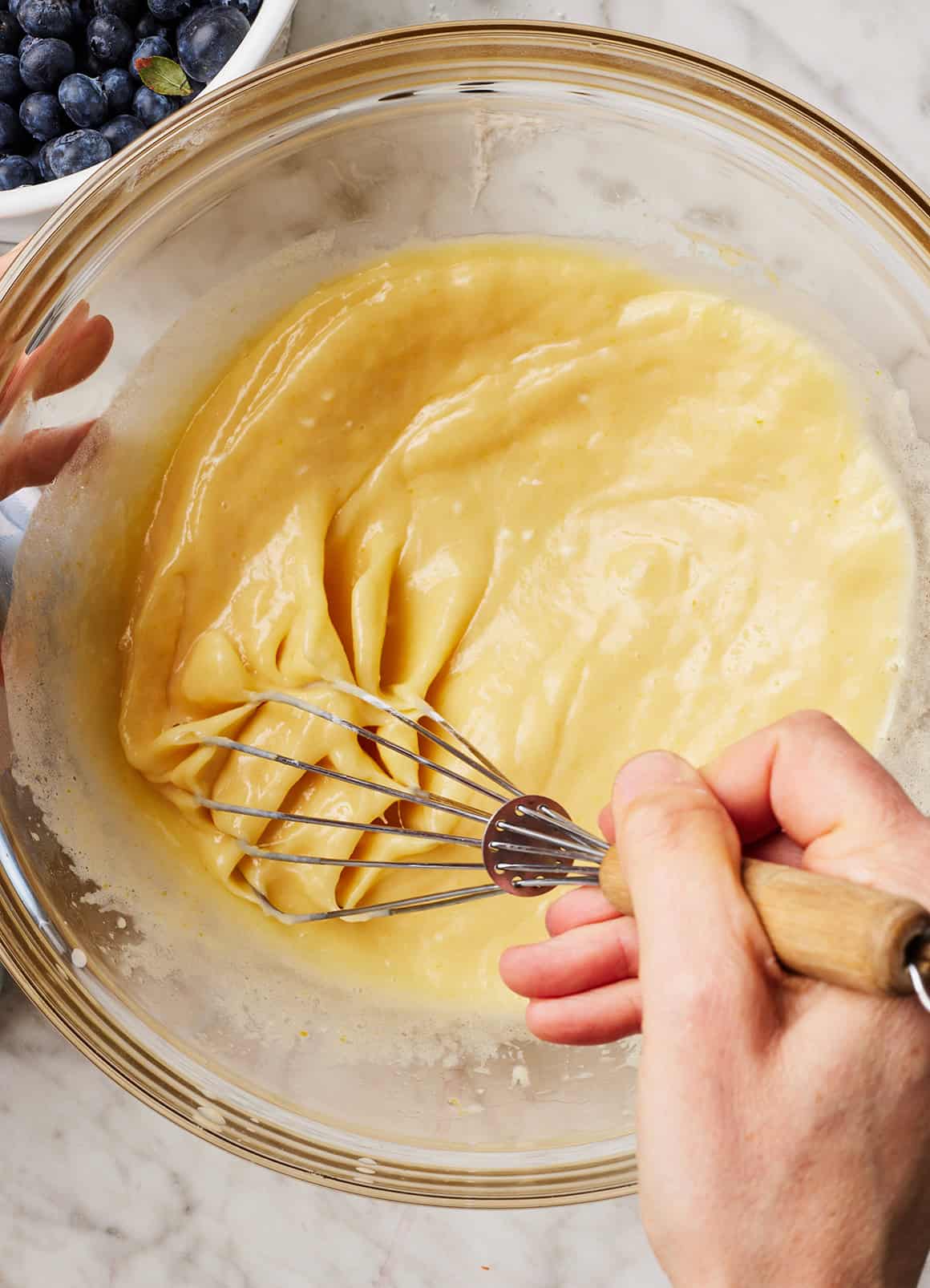 Whisking wet ingredients in glass mixing bowl