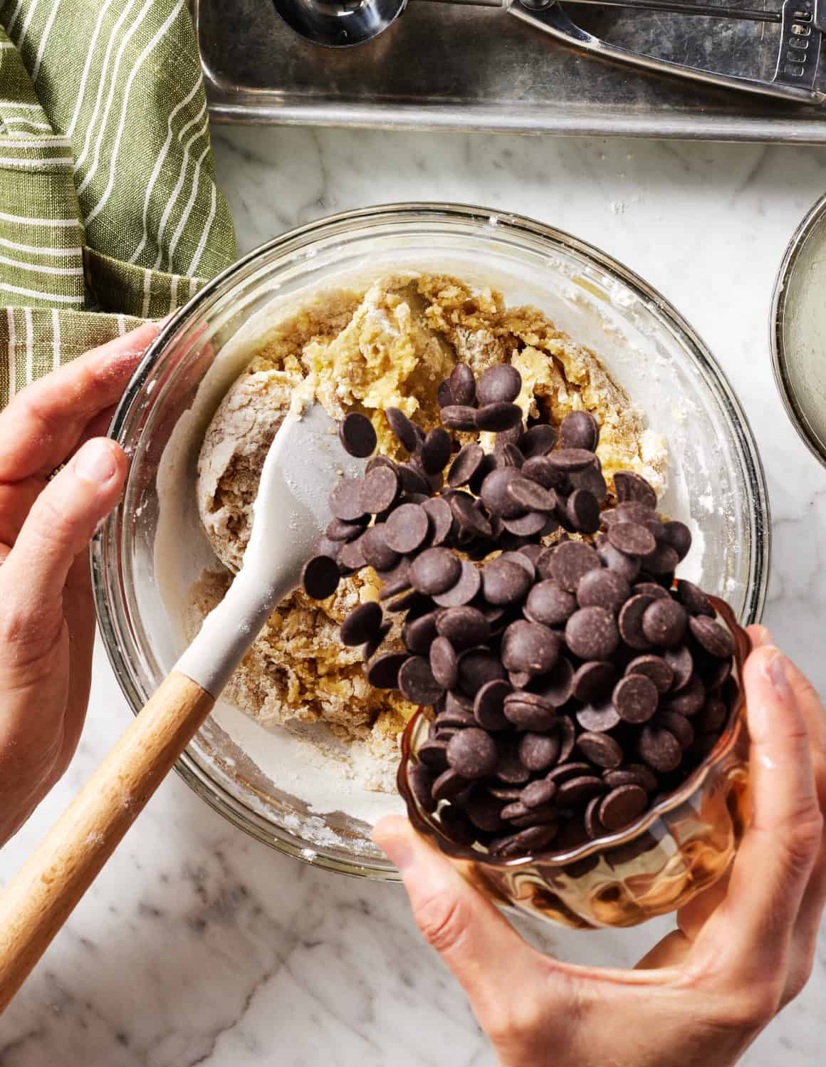 Adding chocolate chips to cookie dough